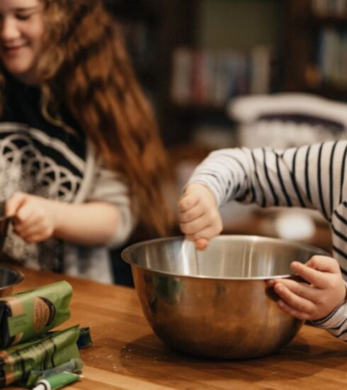 Cooking - woman in black and white striped long sleeve shirt holding stainless steel bowl