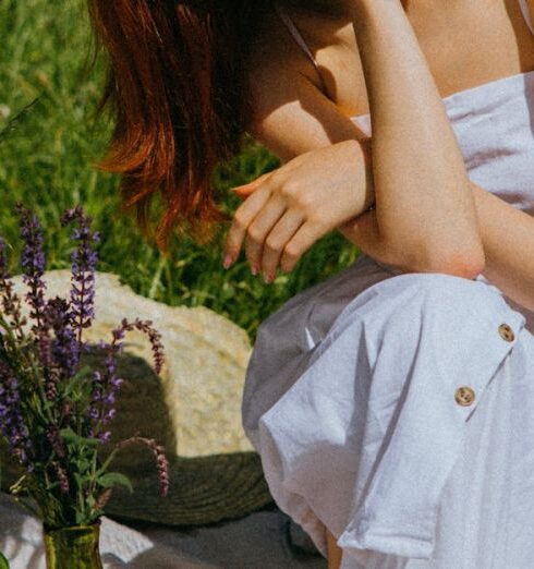 Foods - A Woman in White Dress Sitting on a Picnic Blanket Surrounded by Foods