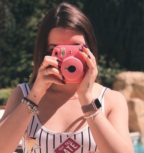 Swimwear - Woman Holding Pink Instant Camera