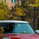 Jackets - A red mini cooper parked on the side of the road