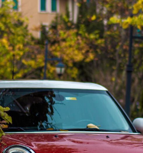 Jackets - A red mini cooper parked on the side of the road