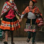 Skirts - Peruvian Girls Wearing Traditional Clothing, Posing by a Heritage Building