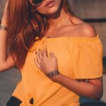 Shorts - Woman Wearing Yellow Off-shoulder Blouse and Black Shorts