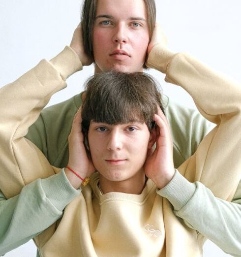 Tracksuits - Men in Tracksuits Covering Ears