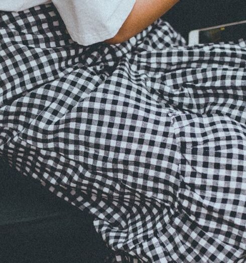 Skirt - Closeup Photo of Girl Playing Portable Console While Sitting in the Sofa