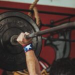 Weightlifting - Person Carrying Black Barbell