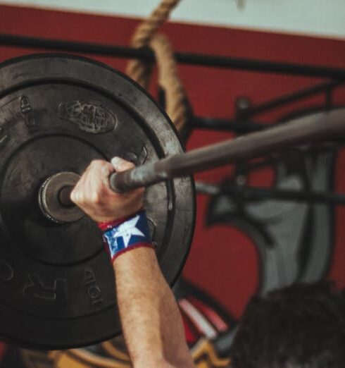 Weightlifting - Person Carrying Black Barbell