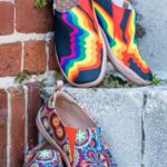 Wedges - A pair of colorful shoes sitting on a brick wall