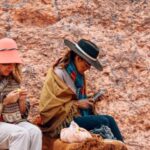 Ponchos - Women Sitting on Rock