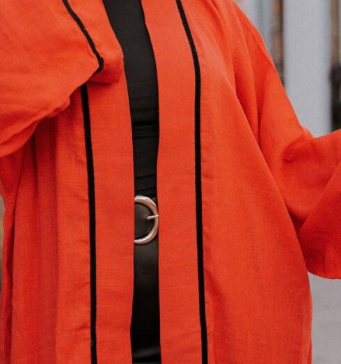 Kaftans - A woman in an orange robe and sunglasses