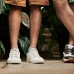 Shorts - Two People Standing Side by Side in Front of Plants