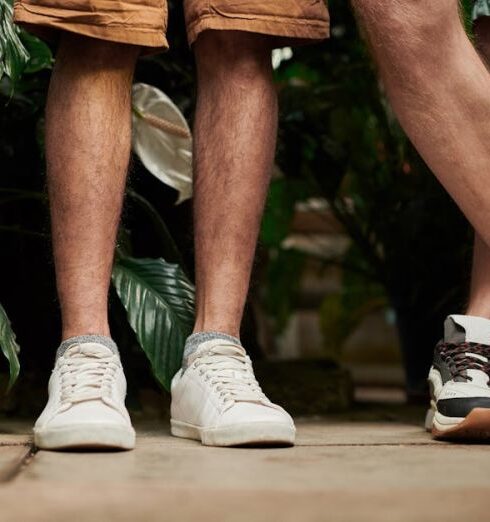 Shorts - Two People Standing Side by Side in Front of Plants