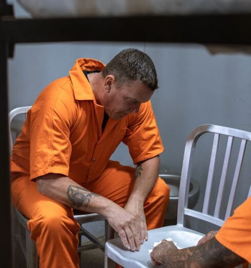 Jumpsuits - Man in Orange Dress Shirt Sitting on Train Seat