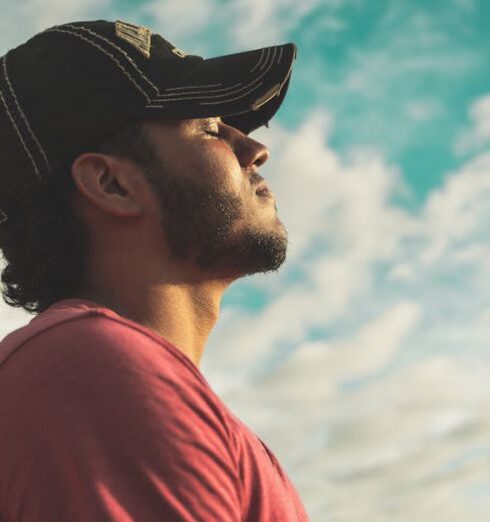 Mindfulness - Man Wearing Black Cap With Eyes Closed Under Cloudy Sky