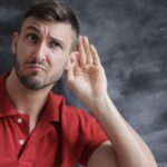 Listening - Man in Red Polo Shirt Sitting Near Chalkboard