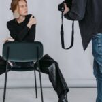 Techniques - Man in Black Long Sleeve Shirt and Blue Denim Jeans Sitting on Black Chair