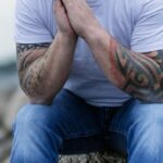 Mindfulness - Man Sitting on Gray Rock on Selective Focus Photo