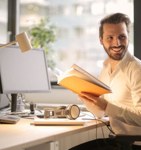 Work - Photo of Man Holding a Book