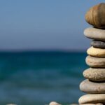 Balance - Cairn Stones and Body of Water in Distance