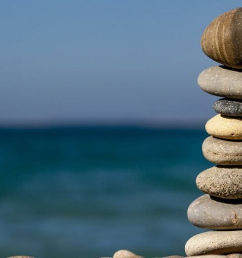 Balance - Cairn Stones and Body of Water in Distance