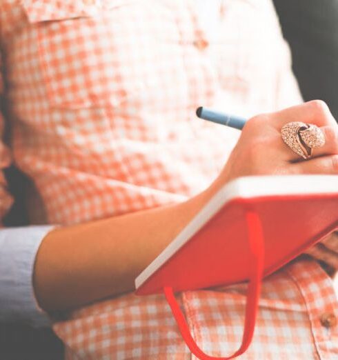 Journaling - Person Writing on Red Notebook