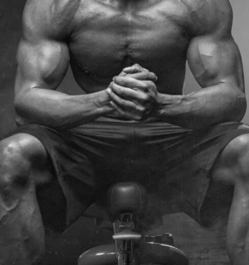 Fitness - Grayscale Photo of Man Sitting on Bench