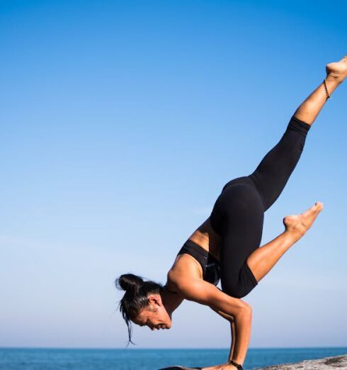 Balance - Low Angle View of Woman Relaxing on Beach Against Blue Sky