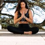 Mindfulness - Woman in Black Tank Top and Black Pants Sitting on Concrete Floor