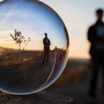 Reflection - Forced Perspective Selective Focus Photography of Man Inside the Ball