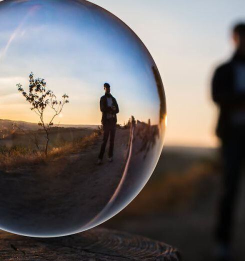 Reflection - Forced Perspective Selective Focus Photography of Man Inside the Ball