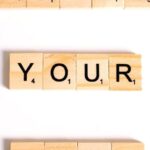 Affirmations - Close-Up Shot of Scrabble Tiles on a White Surface