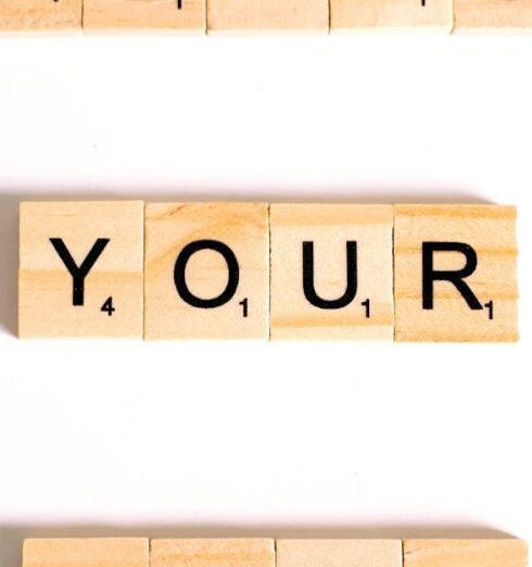 Affirmations - Close-Up Shot of Scrabble Tiles on a White Surface