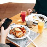 Eating - Two Dinner Plates on Square Brown Wooden Bar Table