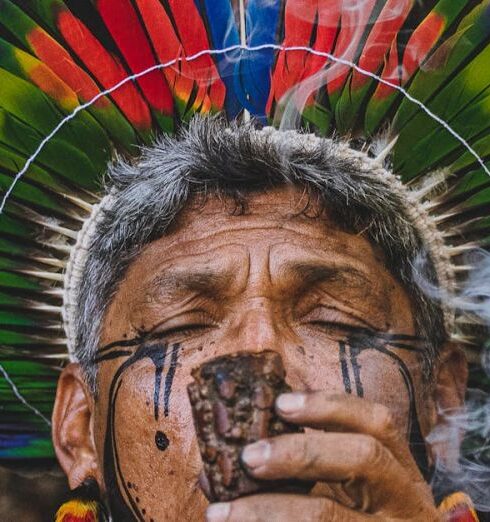 Practices - Man in Traditional Plume Smoking Pipe