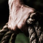 Strength - Man Holding Brown Rope