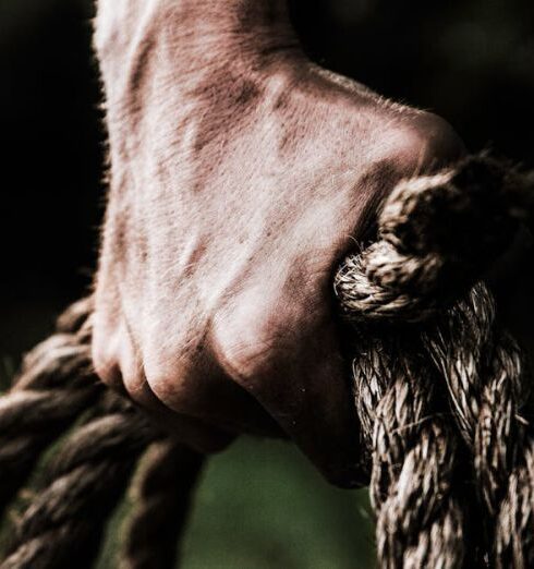 Strength - Man Holding Brown Rope