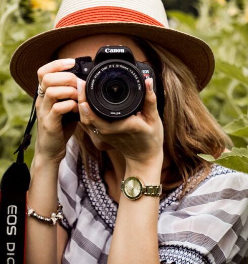 Photography - Selective Focus Photography of Woman Holding Dslr Camera