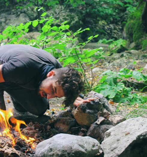 Survival - Man Checking Bonfire at Forest