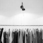 Clothing - Grayscale Photography of Assorted Shirts Hanged on Clothes Rack