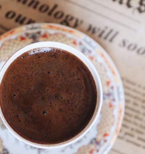 Routines - Cup of Black Coffee Lying on Newspaper in Bed