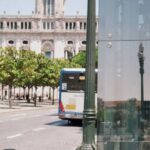 Routines - A bus stop with a reflection of a building