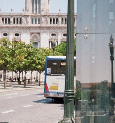 Routines - A bus stop with a reflection of a building