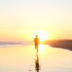 Running - Silhouette of Boy Running in Body of Water during Sunset