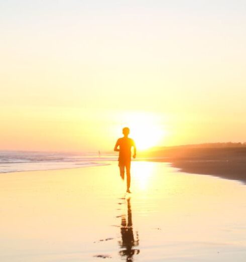 Running - Silhouette of Boy Running in Body of Water during Sunset