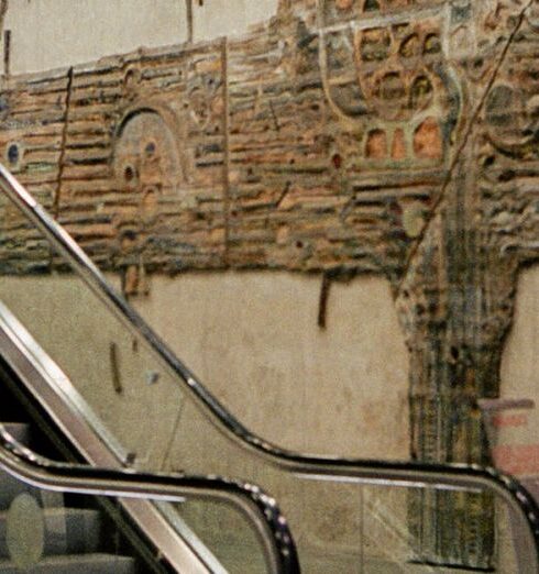 Routines - A woman is walking down an escalator in a subway station