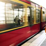 Commute - Woman Standing Beside Red Train