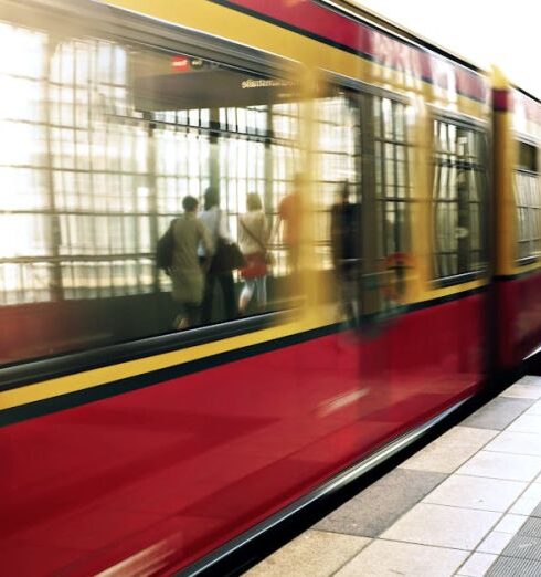 Commute - Woman Standing Beside Red Train