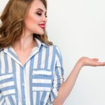 Fashion - Woman in Blue and White Striped Top Raising Her Left Hand