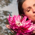 Wellness - Woman Holding Pink Water Lily Flowers