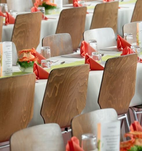 Events - Long Tables With White Cloths and Brown Chairs Formal Setting